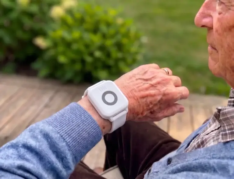 Senior man wearing the Bedford Go Anywhere fall detection watch outdoors in Canada